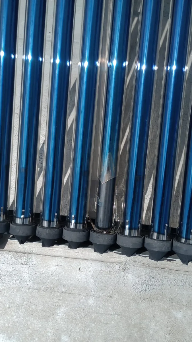 solar geyser technician assessing an evacuated tube installation for a 100 litre conversion
